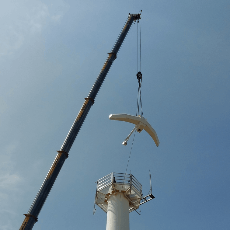 Installing a parabolic reflector radar antenna.